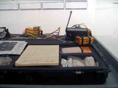 <i>BPL-001 Mission (Conrad Carpenter Funeral)</i> [detail], 2007, waterproof case with objects comprising near space vehicle, aluminum, nylon, polycarbonate, dacron, mylar, electronics, steel, brass, paper, urethane, 6 x 53 x 16 inches (15 x 135 x 40.5 cm)