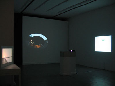 <i>Mortal Coil</i>, exhibition view, Parker's Box, 2008; clockwise left to right: John Gerrard, <i>Grow / Finish Unit (Eva Oklahoma)</i>, 2008; Simon Faithfull, <i>Orbital No.1</i>, 2002; Edith Dekyndt, <i>Slow Object 05</i>, 2004